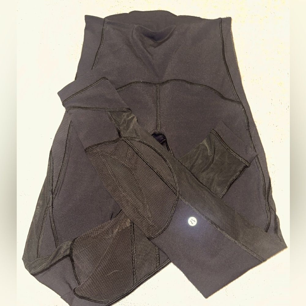 Lululemon 7/8 black leggings with mesh detail.